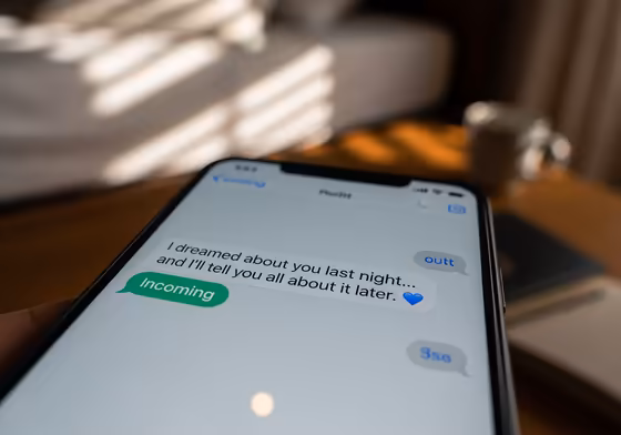 A smartphone screen showing a flirty good morning text message with a winking emoji.